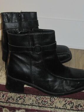 Black leather ankle boots with buckle detail. Size: US 9 
 Decorative Strap